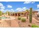 Charming backyard showcasing desert landscaping, a covered patio, and refreshing pool at 14426 W Becker Ln, Surprise, AZ 85379