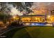 Stunning backyard with a pool, putting green, and covered patio, perfect for outdoor living and entertaining at 14426 W Becker Ln, Surprise, AZ 85379