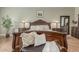 This main bedroom features a stately, solid wood carved bed with decorative accents and comfortable textures at 14426 W Becker Ln, Surprise, AZ 85379