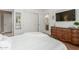 This bedroom features wood-style tile flooring, ensuite access, and neutral decor at 14426 W Becker Ln, Surprise, AZ 85379