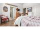 This bedroom features a unique, rustic, four-poster bed and wood-style tile flooring at 14426 W Becker Ln, Surprise, AZ 85379