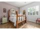 This bedroom features a unique, rustic, four-poster bed and wood-style tile flooring at 14426 W Becker Ln, Surprise, AZ 85379