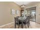 Cozy dining room featuring elegant chandelier, wainscoting, and easy access to the outdoor patio at 14426 W Becker Ln, Surprise, AZ 85379
