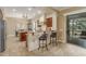 Stylish kitchen with a breakfast bar, granite countertops, and seamlessly flowing to the dining area at 14426 W Becker Ln, Surprise, AZ 85379
