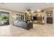 Spacious living room with a sleek media center, neutral tones, and sliding glass doors to the backyard at 14426 W Becker Ln, Surprise, AZ 85379