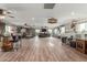 Spacious living room with hardwood floors, custom bar, large-screen tv, and lots of room to roam at 14426 W Becker Ln, Surprise, AZ 85379