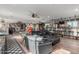 Large living room with hardwood floors, custom bar, black leather couch and many cool decorations at 14426 W Becker Ln, Surprise, AZ 85379