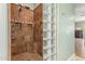 This tiled shower is highlighted by glass block and multiple shower heads at 14426 W Becker Ln, Surprise, AZ 85379