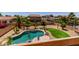 Aerial view of backyard showcasing the sparkling pool, artificial grass and desert landscaping at 15683 W Minnezona Ave, Goodyear, AZ 85395