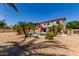 Expansive backyard with a pool, palm trees, and plenty of room for outdoor activities at 15683 W Minnezona Ave, Goodyear, AZ 85395