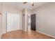 Bedroom with a closet and ceiling fan, neutral paint, and tile flooring at 15683 W Minnezona Ave, Goodyear, AZ 85395