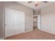 Bedroom with carpet, a closet and easy access to the home's staircase at 15683 W Minnezona Ave, Goodyear, AZ 85395