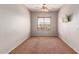 Bedroom with a ceiling fan, neutral carpeting, neutral paint and one window with blinds at 15683 W Minnezona Ave, Goodyear, AZ 85395