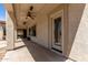 Inviting covered patio with ceiling fans and a convenient door leading to the home's interior at 15683 W Minnezona Ave, Goodyear, AZ 85395