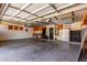Spacious garage featuring overhead storage racks and a well-lit interior at 15683 W Minnezona Ave, Goodyear, AZ 85395