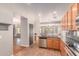 Open kitchen with stainless steel appliances and breakfast bar leading to the living and dining areas at 15683 W Minnezona Ave, Goodyear, AZ 85395