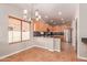 Eat-in kitchen with wood cabinetry, a black backsplash, and stainless steel appliances at 15683 W Minnezona Ave, Goodyear, AZ 85395