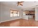 Living area with wood floors, a window, and kitchen access, perfect for entertaining at 15683 W Minnezona Ave, Goodyear, AZ 85395