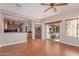 Open-concept living area with hardwood floors, a sliding glass door, and kitchen access at 15683 W Minnezona Ave, Goodyear, AZ 85395