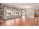 Bright living room features wood floors, large windows, and a modern light fixture at 15683 W Minnezona Ave, Goodyear, AZ 85395