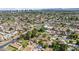 Wide aerial shot showing a neighborhood with mature trees, a home with a sprawling backyard, and city views at 1720 W Elm St, Phoenix, AZ 85015