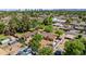 Aerial view of home with spacious backyard, mature trees, and views of the city skyline at 1720 W Elm St, Phoenix, AZ 85015