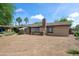 A large backyard featuring green trees and a dirt area ready for landscaping at 1720 W Elm St, Phoenix, AZ 85015