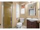 Full bathroom featuring a glass shower and single sink vanity with earth tone paint at 1720 W Elm St, Phoenix, AZ 85015