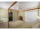 Bedroom with a four-post bed frame, carpet floors, ceiling fan, and closet at 1720 W Elm St, Phoenix, AZ 85015