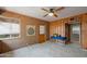 Bonus room featuring a ceiling fan, natural light, and rustic adobe and wood-paneled walls at 1720 W Elm St, Phoenix, AZ 85015