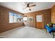 Sunlit bonus room with unique adobe walls, a ceiling fan, and multiple windows, creating a bright, versatile space at 1720 W Elm St, Phoenix, AZ 85015