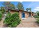 Home exterior with Southwestern style, including colorful blue doors, a desert landscape, and a neutral paint scheme at 1720 W Elm St, Phoenix, AZ 85015