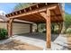 A wooden car port beside a garage shows the well-maintained property with a sturdy, covered parking area at 1720 W Elm St, Phoenix, AZ 85015