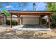 The detached garage features a wooden carport, providing shaded parking and complementing the home's style at 1720 W Elm St, Phoenix, AZ 85015