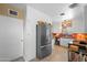 Bright kitchen features stainless steel refrigerator, white cabinets and vintage tile countertops at 1720 W Elm St, Phoenix, AZ 85015