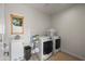 Clean laundry room featuring a front load washer and dryer set and a stainless steel utility sink at 1720 W Elm St, Phoenix, AZ 85015