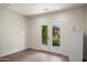 Spacious room with neutral walls and French doors that offer a glimpse into the serene backyard at 1720 W Elm St, Phoenix, AZ 85015