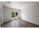Bright room with stylish wood-look flooring and French doors opening to a serene garden view at 1720 W Elm St, Phoenix, AZ 85015