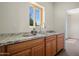 Stylish wet bar featuring granite counters, wood cabinets, and a brushed nickel faucet fixture at 1720 W Elm St, Phoenix, AZ 85015