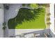 Aerial view of backyard with manicured landscaping, artificial turf, and paver patio at 20217 W Desert Bloom St, Buckeye, AZ 85326