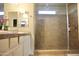 Modern bathroom features a glass-enclosed shower, double sinks, and ample counter space at 20217 W Desert Bloom St, Buckeye, AZ 85326