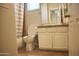 Cozy bathroom featuring white cabinetry, tile flooring, and a shower with a curtain at 20217 W Desert Bloom St, Buckeye, AZ 85326