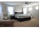 Bright, open bedroom with great windows, a ceiling fan, and stylish decor creates a relaxing space at 20217 W Desert Bloom St, Buckeye, AZ 85326