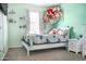 Bright bedroom with light walls, carpet floors, white trim and doors, and ample natural light at 20217 W Desert Bloom St, Buckeye, AZ 85326