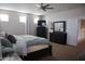 Spacious bedroom with carpet, ceiling fan, and large windows letting in plenty of natural light at 20217 W Desert Bloom St, Buckeye, AZ 85326