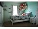 Bright bedroom with blue walls, window and decor at 20217 W Desert Bloom St, Buckeye, AZ 85326