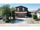 Charming two-story home features a neutral color scheme, tiled roof, and a two-car garage at 20217 W Desert Bloom St, Buckeye, AZ 85326