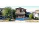 Charming two-story home with a two-car garage, drought-tolerant landscaping, and a well-manicured lawn at 20217 W Desert Bloom St, Buckeye, AZ 85326