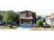 Two-story home with a well-maintained lawn and xeriscaping, complemented by a two-car garage and inviting entry at 20217 W Desert Bloom St, Buckeye, AZ 85326