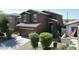 Well-maintained home showcases a two-car garage, tiled roof, and manicured landscaping at 20217 W Desert Bloom St, Buckeye, AZ 85326
